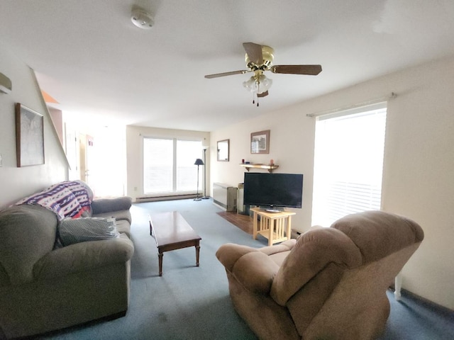 carpeted living area featuring ceiling fan