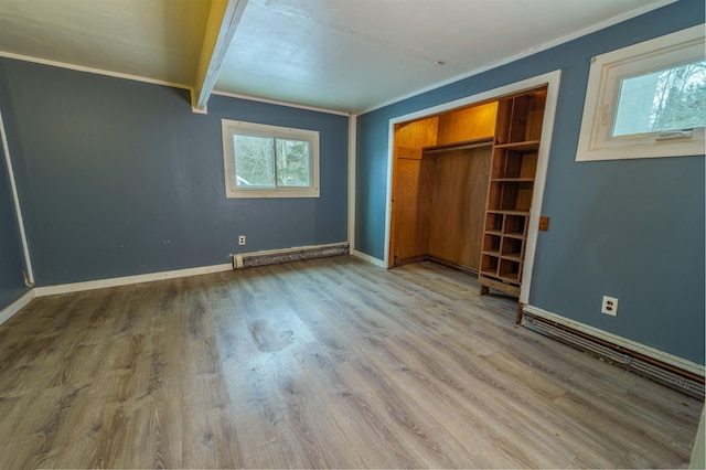 unfurnished bedroom with a baseboard heating unit, wood finished floors, baseboards, beamed ceiling, and crown molding