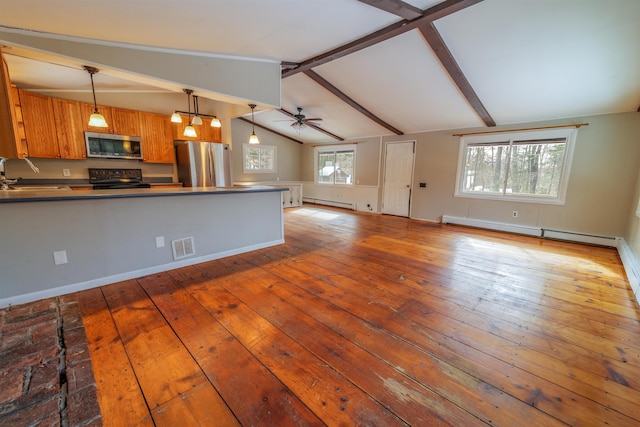 kitchen featuring lofted ceiling with beams, a baseboard radiator, a peninsula, stainless steel appliances, and a sink