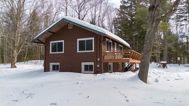 view of snowy exterior featuring a wooden deck