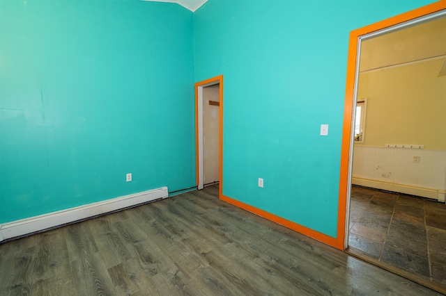 unfurnished bedroom featuring a baseboard radiator and wood finished floors