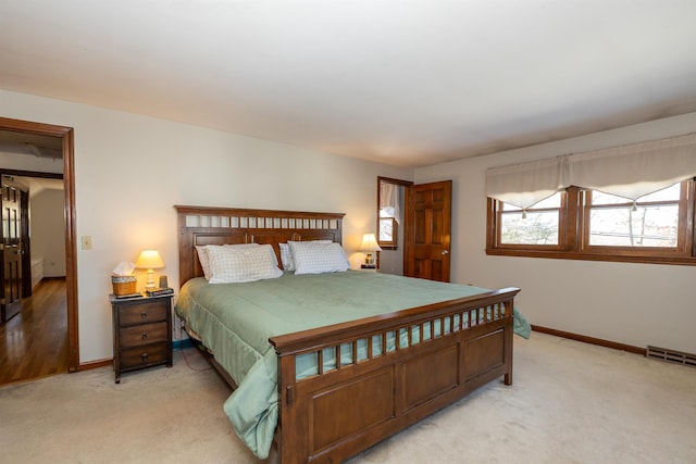 bedroom featuring baseboards, visible vents, and light colored carpet