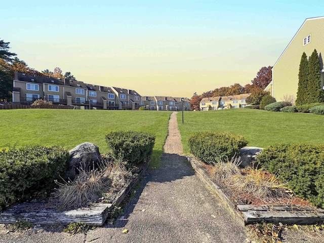 view of home's community featuring a residential view and a yard