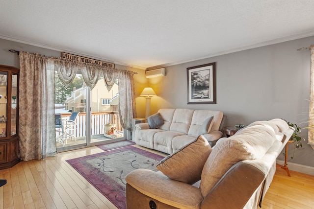 living room with hardwood / wood-style floors, crown molding, a textured ceiling, and an AC wall unit