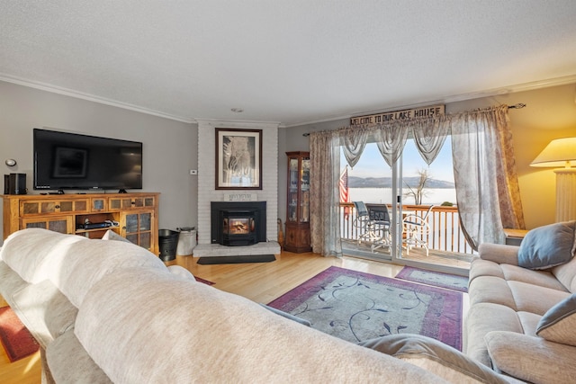 living room featuring a textured ceiling, wood finished floors, and crown molding