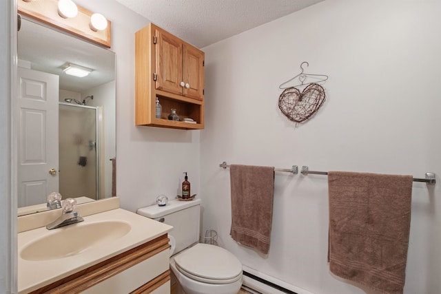 bathroom with a stall shower, vanity, toilet, and a textured ceiling