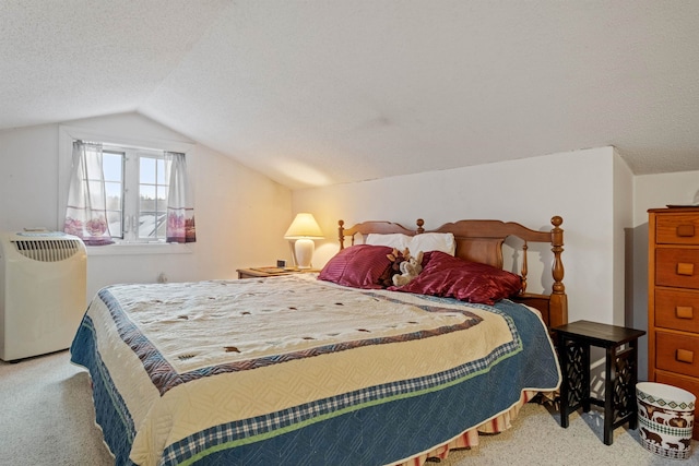 carpeted bedroom with vaulted ceiling and a textured ceiling