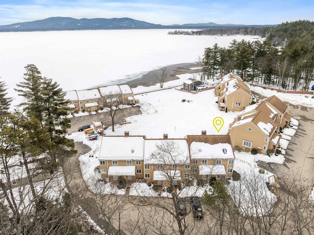 snowy aerial view featuring a mountain view