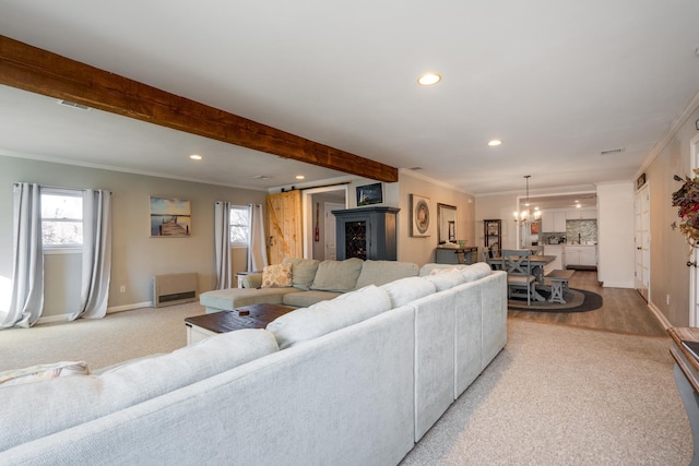 living room featuring beam ceiling, recessed lighting, an inviting chandelier, ornamental molding, and baseboards