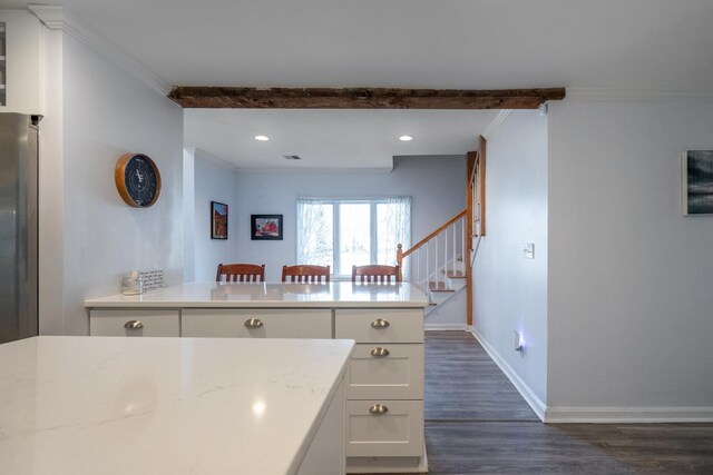 kitchen featuring dark wood-type flooring, white cabinets, and crown molding