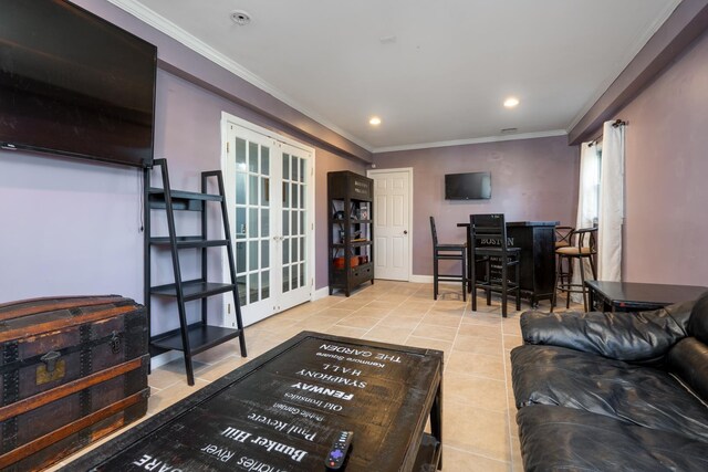 living area featuring tile patterned flooring, recessed lighting, french doors, a dry bar, and crown molding