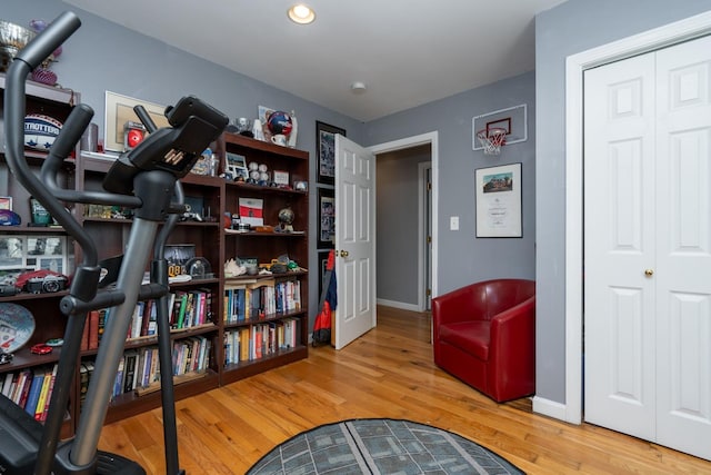 living area with baseboards and wood finished floors