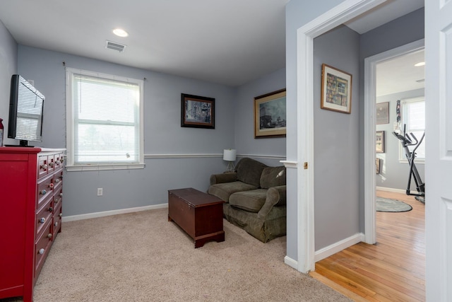 sitting room featuring carpet, visible vents, and baseboards