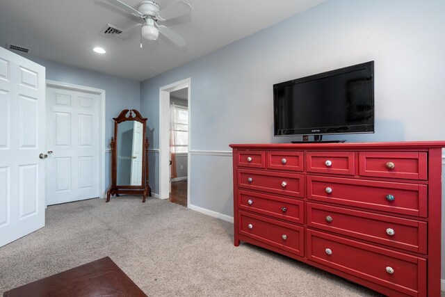 bedroom with baseboards, visible vents, ceiling fan, and light colored carpet