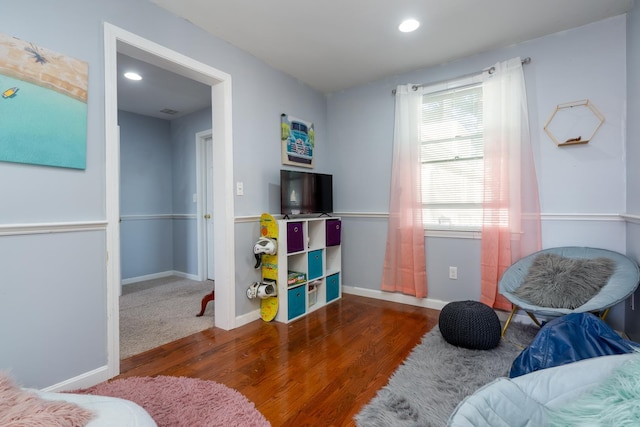 interior space featuring recessed lighting, baseboards, and wood finished floors