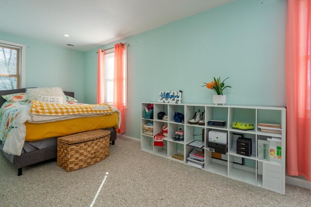 carpeted bedroom featuring baseboards and recessed lighting