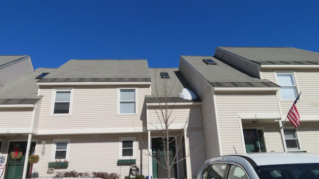 multi unit property featuring metal roof, a shingled roof, and a standing seam roof