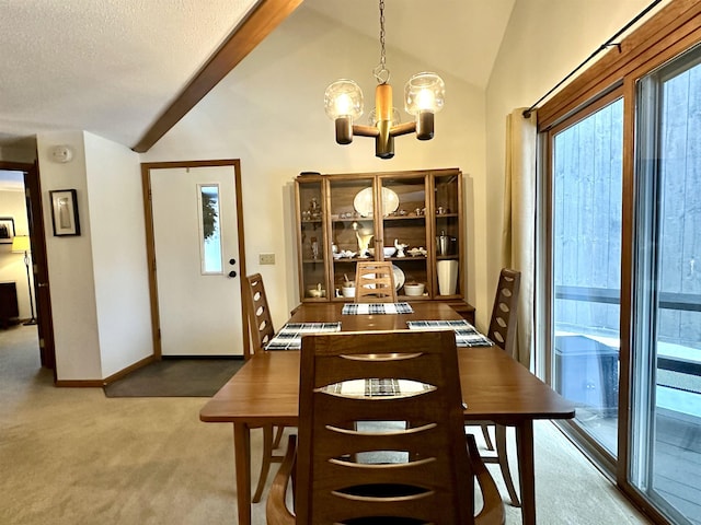 carpeted dining room with lofted ceiling with beams, baseboards, a chandelier, and a textured ceiling