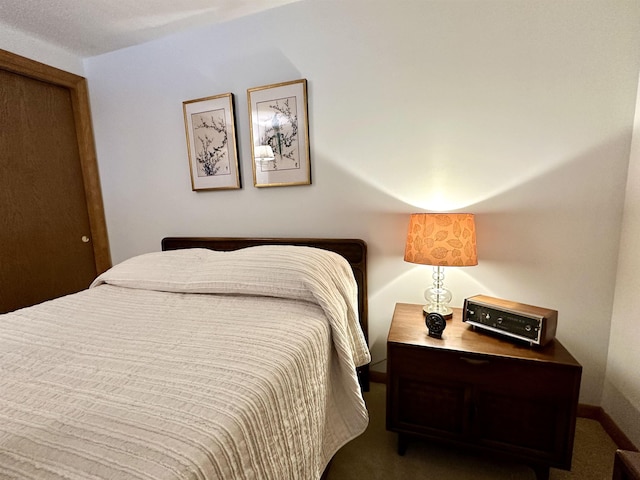 bedroom featuring carpet and baseboards