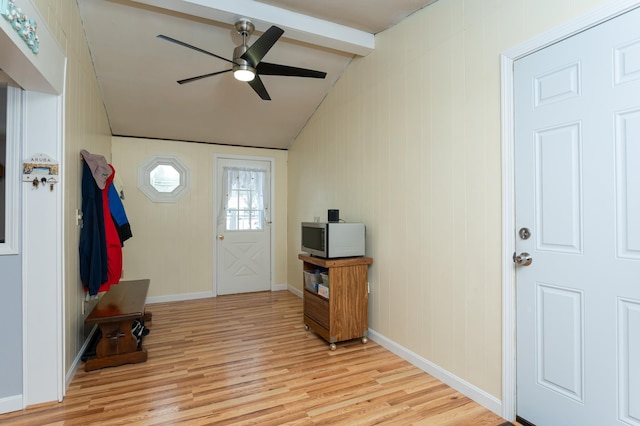 foyer featuring lofted ceiling with beams, light wood-style floors, ceiling fan, and baseboards