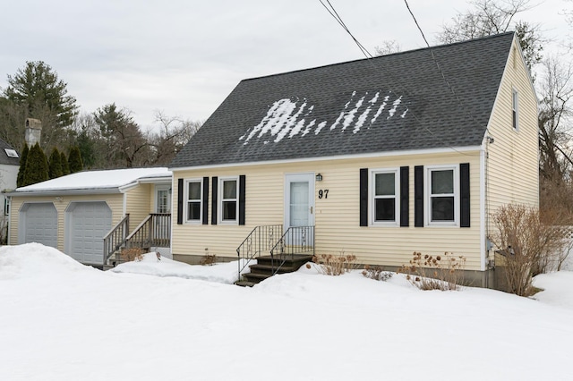 view of front of home featuring an attached garage and a shingled roof