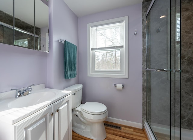 full bath featuring visible vents, toilet, a shower stall, wood finished floors, and baseboards