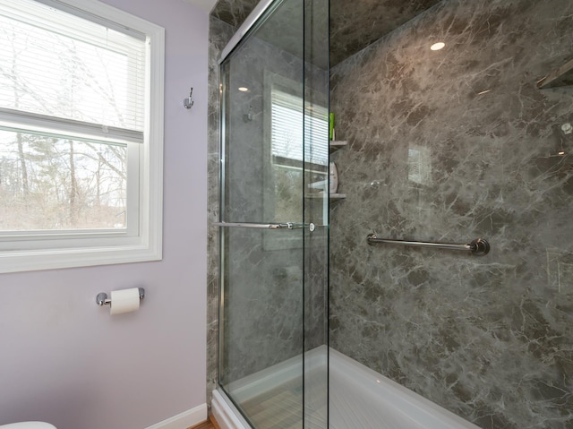 full bathroom featuring a stall shower and plenty of natural light