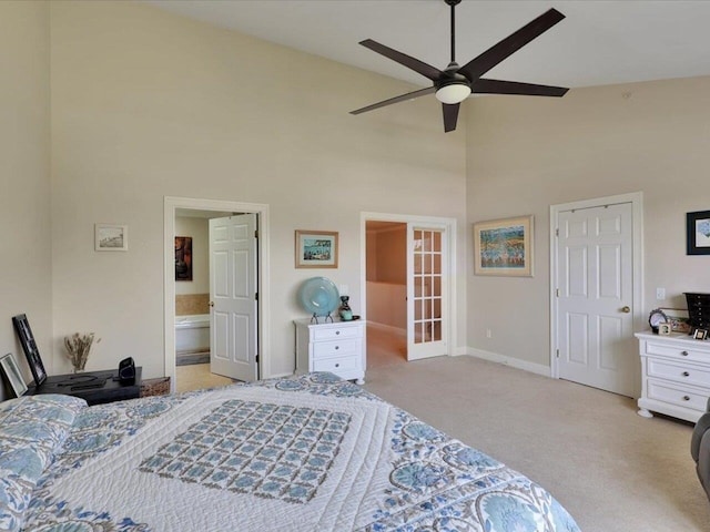 bedroom featuring carpet, french doors, connected bathroom, high vaulted ceiling, and baseboards