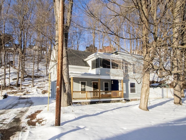 view of front facade featuring covered porch and a balcony