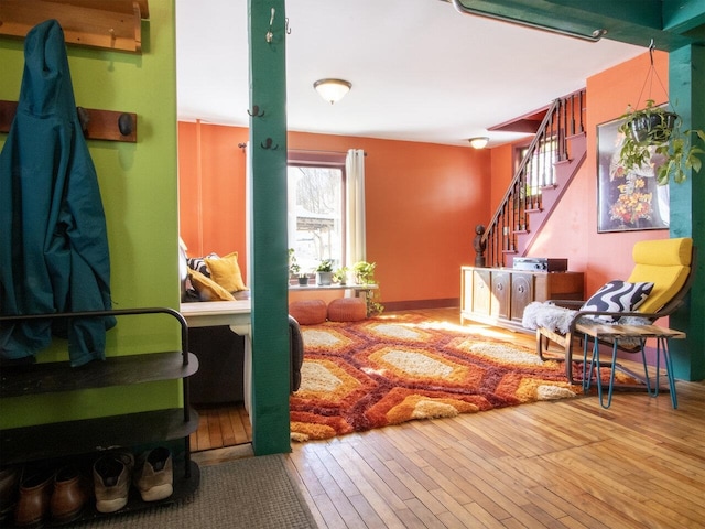 living area featuring hardwood / wood-style floors and stairs