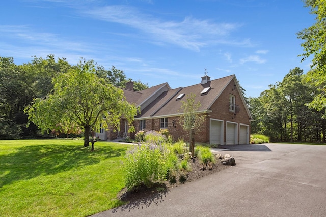 view of property exterior featuring a yard, brick siding, and driveway