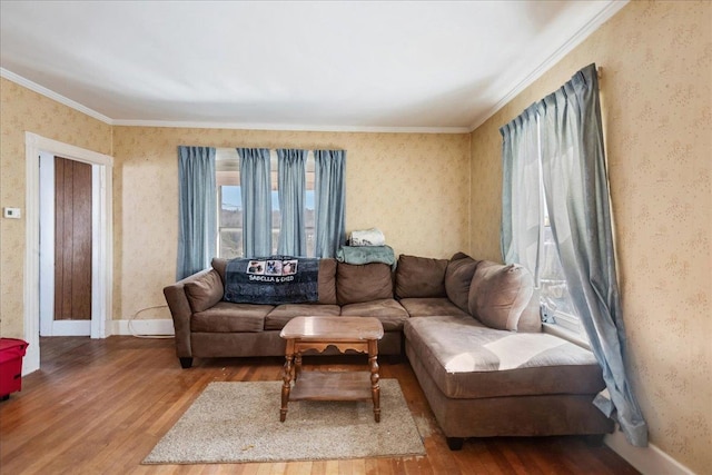 living area with crown molding, baseboards, wood finished floors, and wallpapered walls