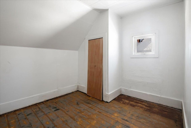 additional living space with lofted ceiling, hardwood / wood-style floors, and baseboards