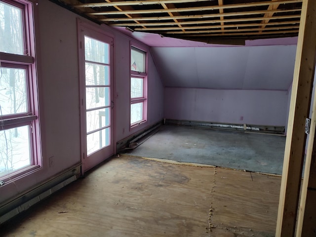 interior space with vaulted ceiling and a baseboard heating unit