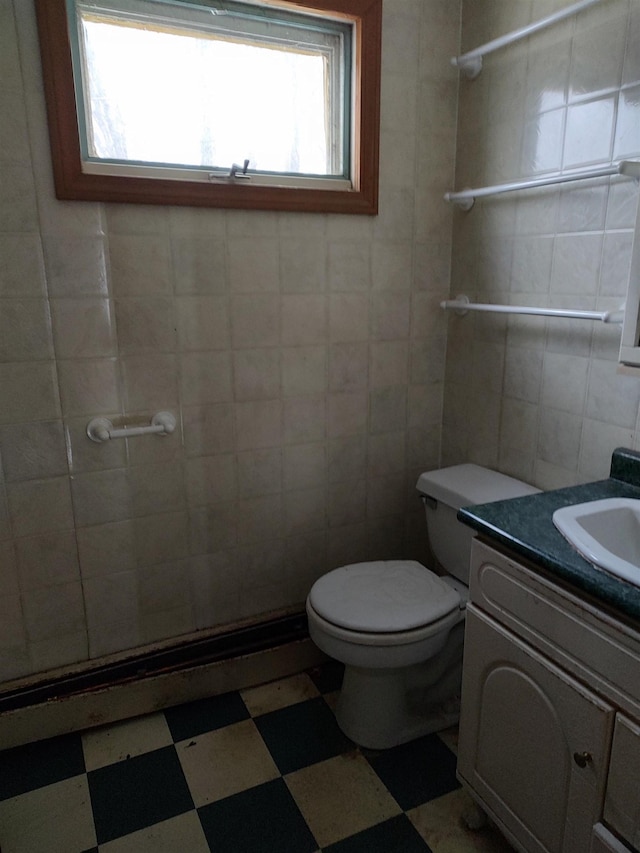 full bath featuring vanity, tile walls, toilet, and tile patterned floors