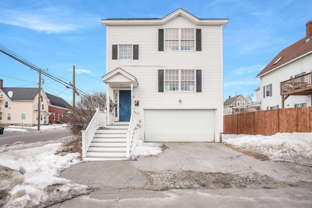 view of front of house with a garage and fence