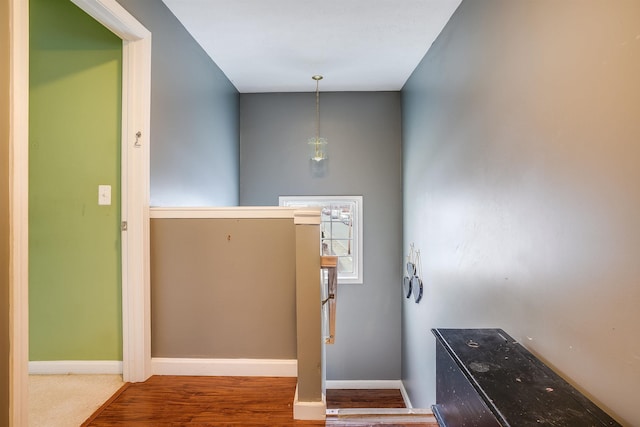 foyer entrance featuring baseboards and wood finished floors