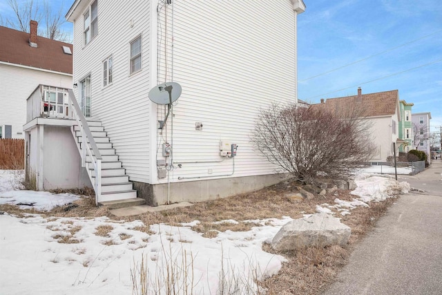 view of side of property featuring stairs