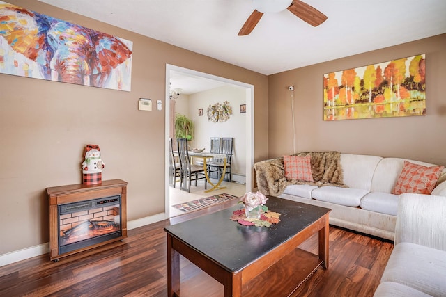 living area with ceiling fan, baseboards, and wood finished floors