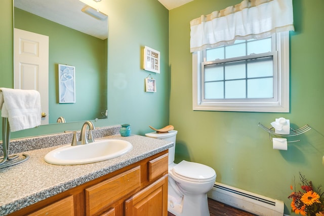 bathroom featuring toilet, baseboard heating, and vanity