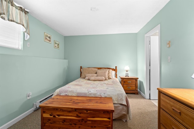 bedroom with a baseboard heating unit, baseboards, and light colored carpet