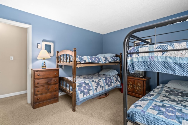 bedroom featuring carpet floors and baseboards