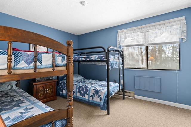 carpeted bedroom with a textured ceiling and baseboards