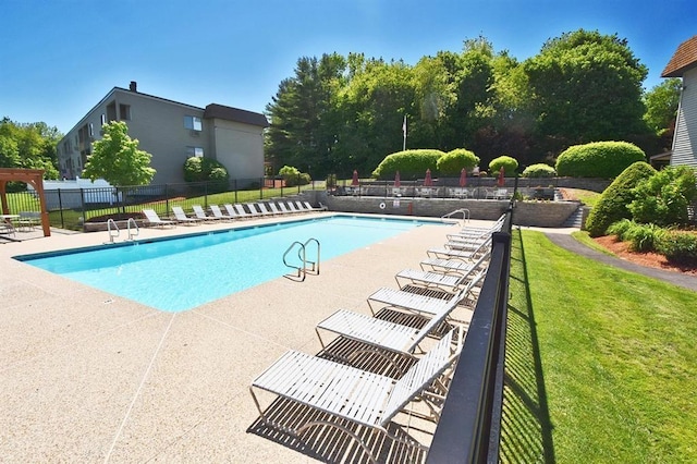 pool with a yard, a patio area, and fence