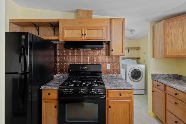 kitchen featuring black appliances, washer / clothes dryer, extractor fan, and tasteful backsplash