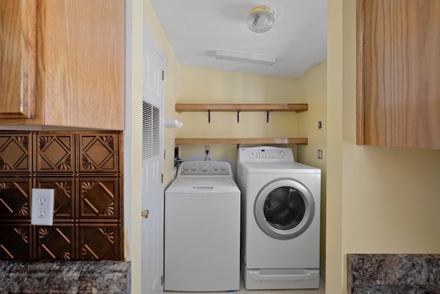 clothes washing area featuring laundry area and washing machine and clothes dryer