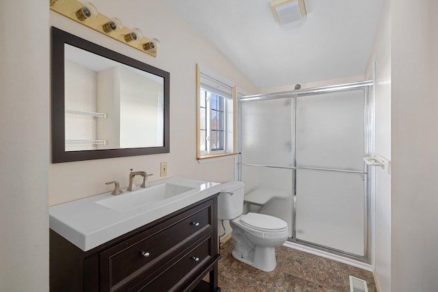 bathroom with toilet, a shower stall, visible vents, and vanity