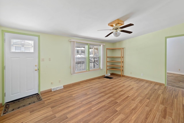 entrance foyer with light wood-style floors, visible vents, ceiling fan, and baseboards