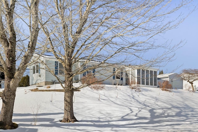 view of front of house with a sunroom