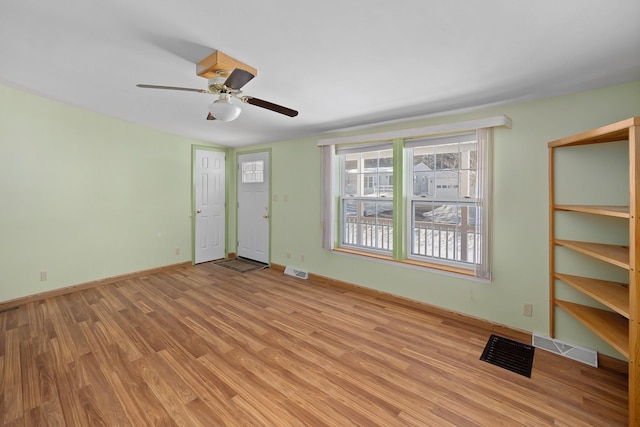 interior space with light wood-type flooring, baseboards, and visible vents